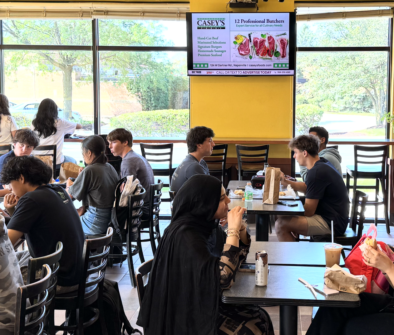 DDM advertising screen inside an active local restaurant