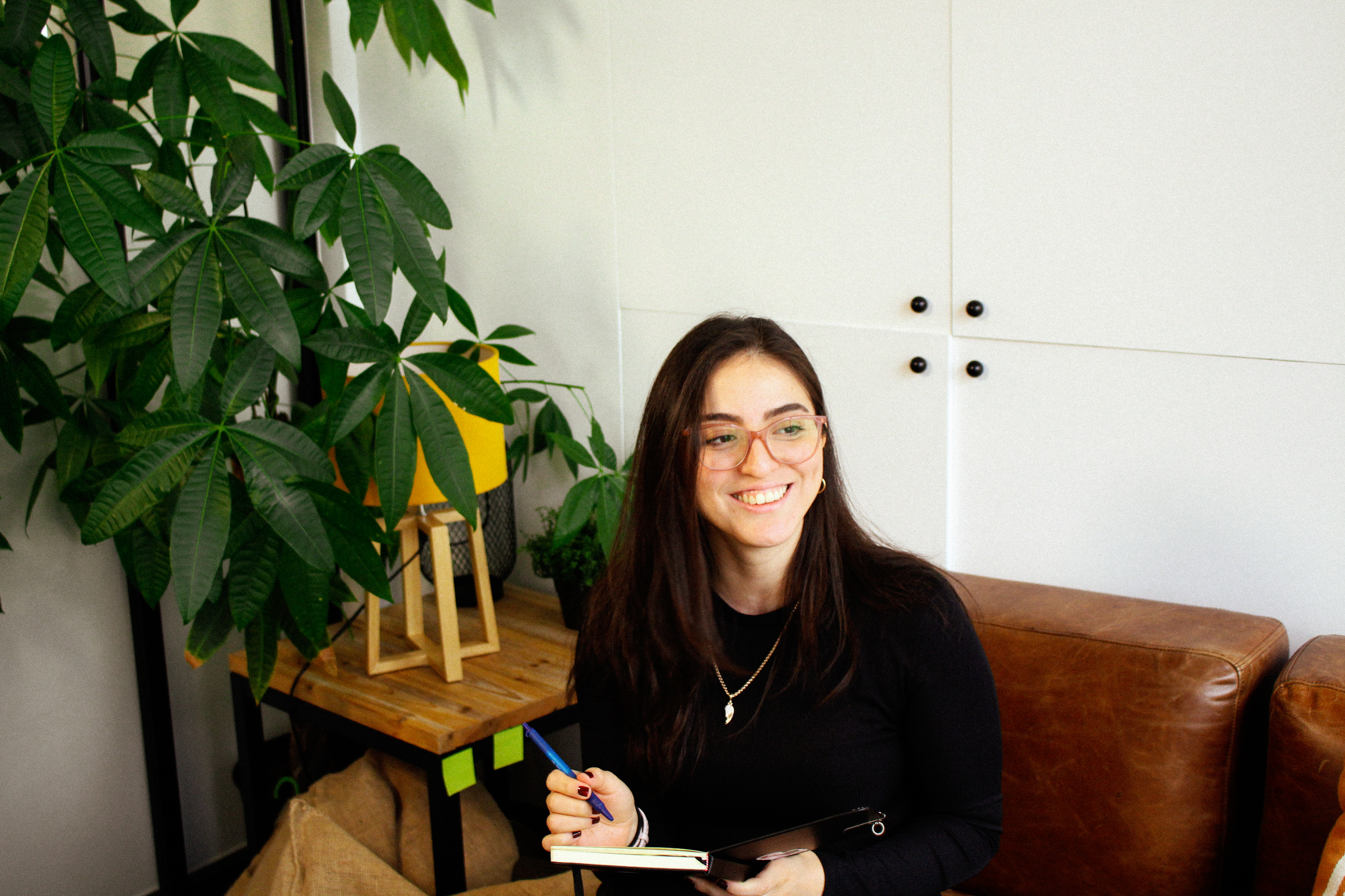 Dessi working with startups, writing notes on a couch